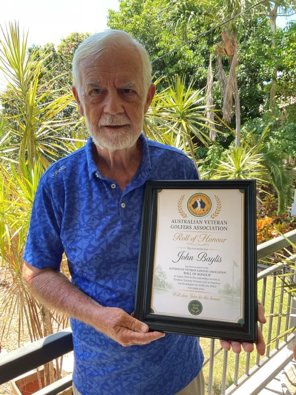 John Baylis holding up his framed Roll of Honour certificate